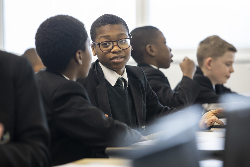 Two students talking to one another in a class