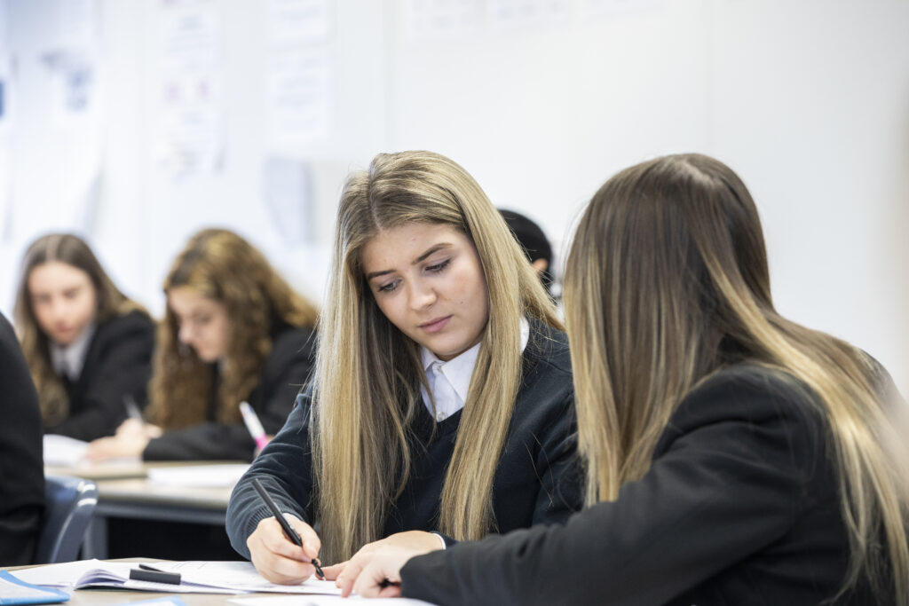 Two female students looking at their work